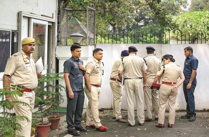 A team of policemen are seen at the main gate of Rahul Gandhi`s residence, waiting for the door to open. (PTI)